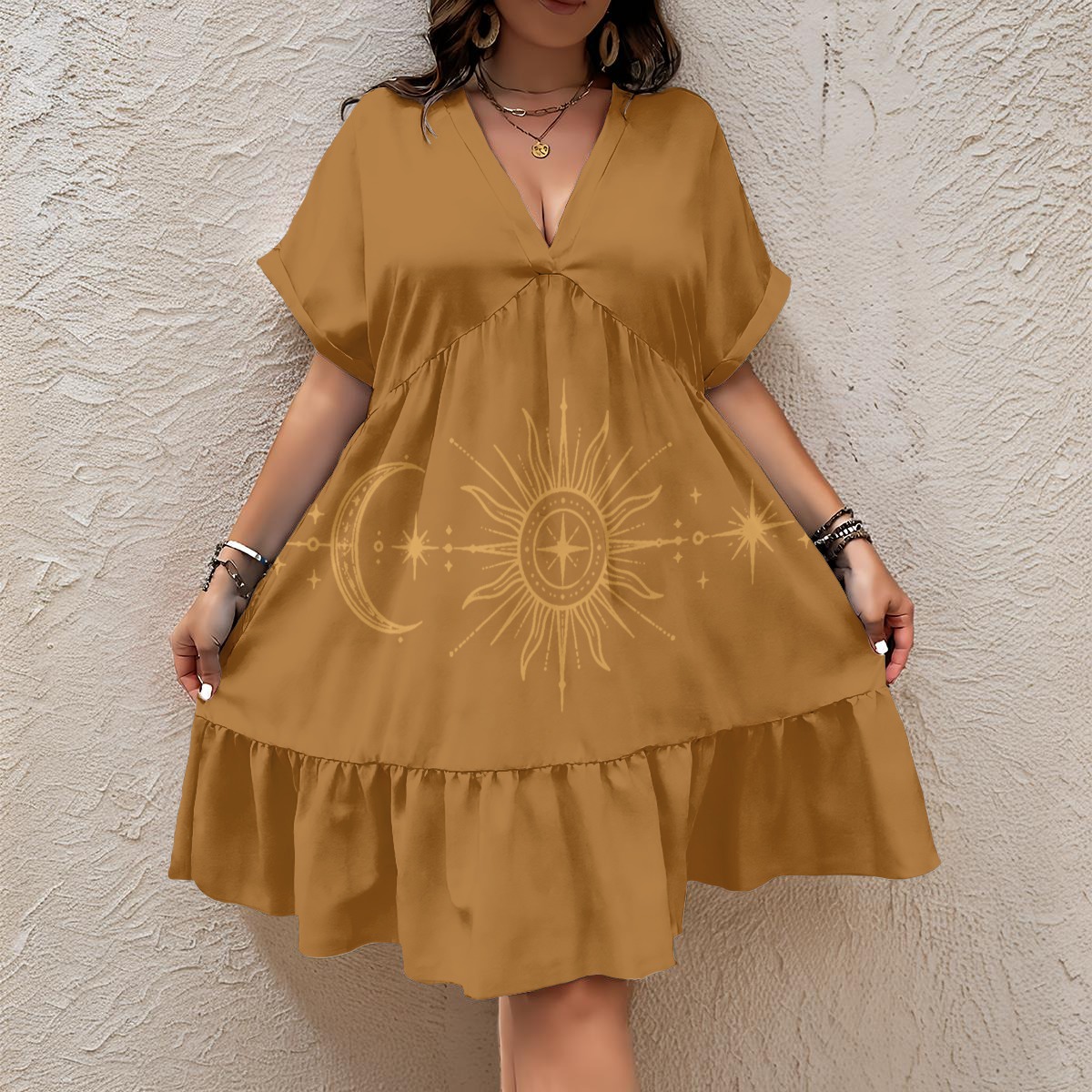 Front view of mustard tiered dress with V-neck and sun, moon, and star graphic.