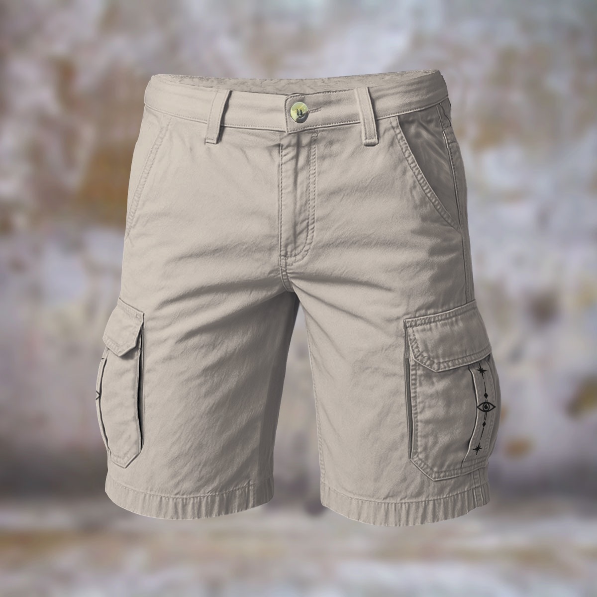 Front view of beige cargo shorts with flap side pockets and printed symbol details
