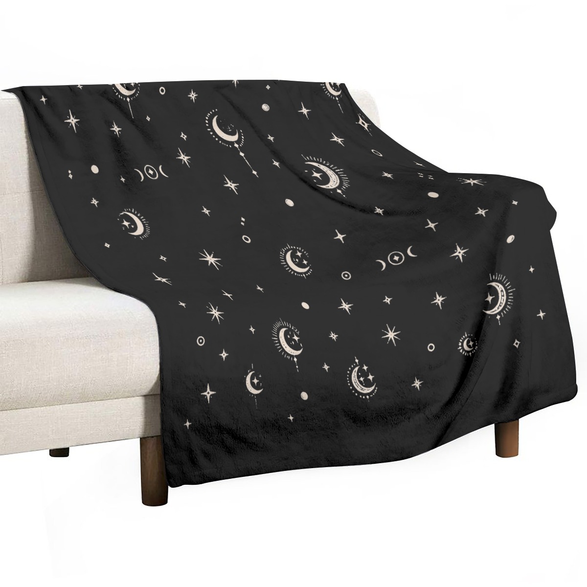Black celestial blanket draped over a light armchair