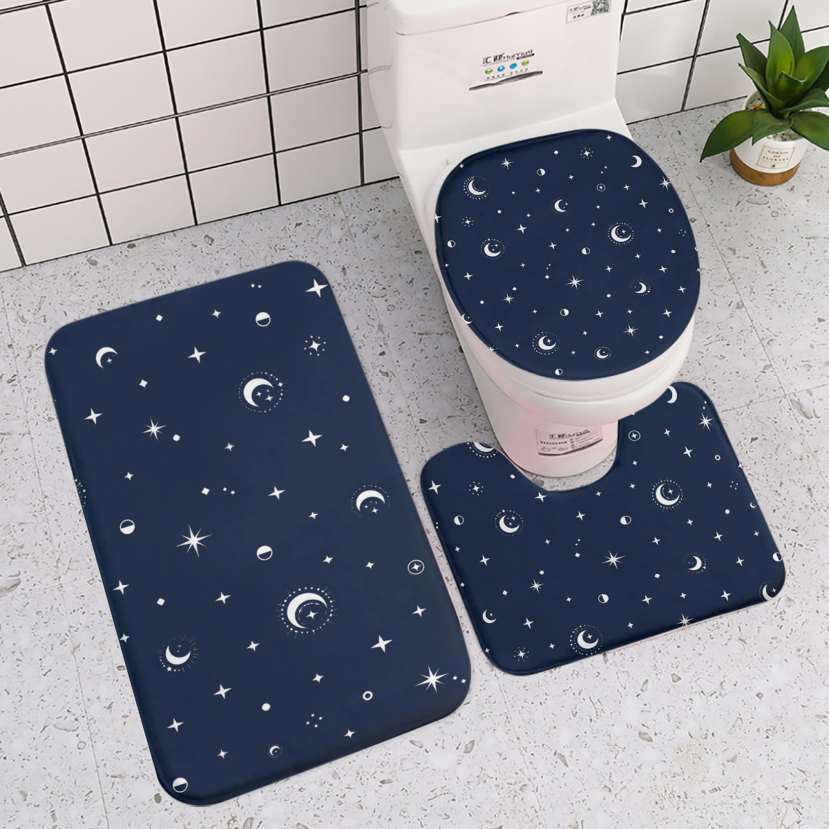 Three-piece bath mat set with navy moon and star print around a toilet