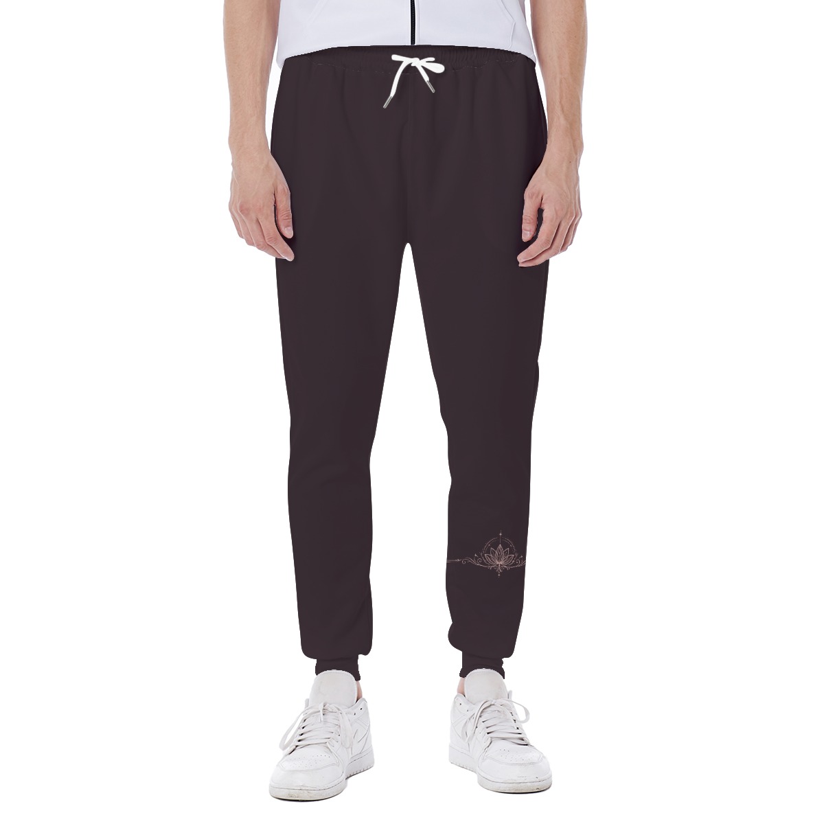 Front view of dark joggers with white drawstring and lotus graphic on lower right leg